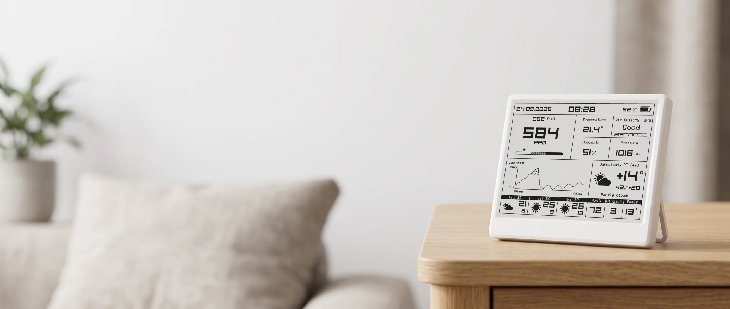 Smart Meteo on its fold-out stand on an oak side table in a bright living room